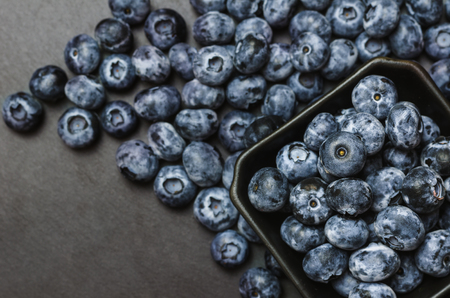 Freshly picked blueberries on shale dark background.の写真素材