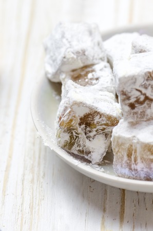 Turkish delight with pistachios on white wooden background.の写真素材
