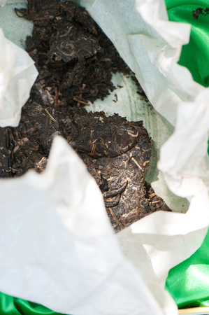 Black Puer tea in green box, closeup. Tea ceremony outdoors.の写真素材