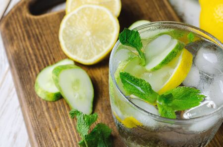 Cold lemonade with lemon, mint and cucumber in glass.の写真素材