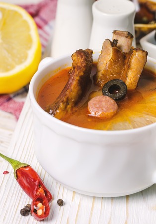Soup with smoked meat, olives and lemon. Solyanka soup.の写真素材