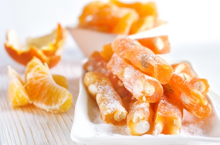 Orange Turkish delight with peanut and orange juice on white background.の写真素材