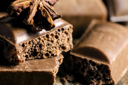 Sweet milk chocolate on wooden background. Close up.の写真素材