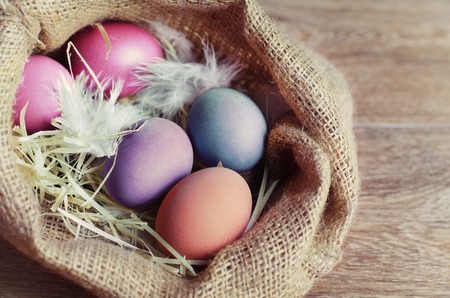 Colorful Easter Eggs on a wooden background