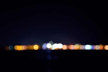 Blurred focus of far away cityscape at night.の写真素材