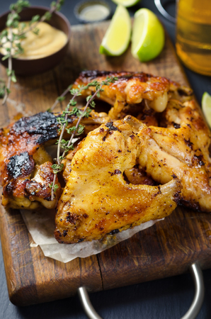 Roasted chicken wings with mustard and lime, beer on backgroundの写真素材