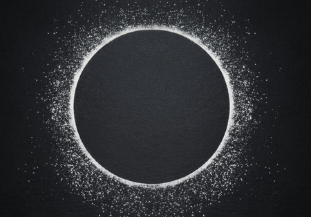 Plate imitation with flour on black background.の写真素材