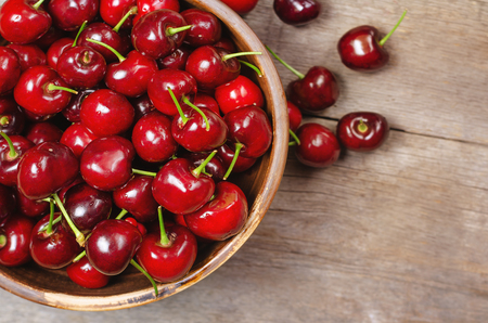 Fresh ripe cherry on wooden background. Close up.の写真素材