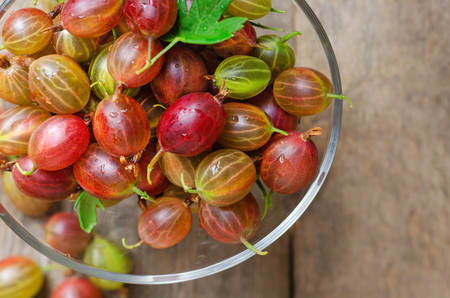 Fresh gooseberry on wooden background. Close up.の写真素材