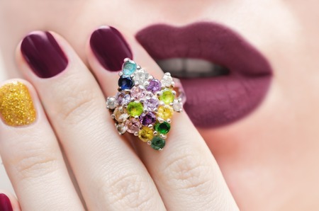 Closeup of an elegant silver ring with color gemstonesの写真素材