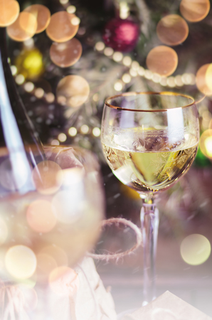 Glass of wine and Christmas decoration on background.の写真素材