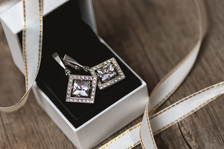 Silver earrings with fianits in white gift box. Gift for christmas.の写真素材