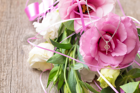 Pink flowers on wooden background. Concept for greetings cardの写真素材