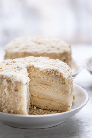 Cake Napoleon on white plate. Russian cuisine, multi layered cake with pastry creamの写真素材