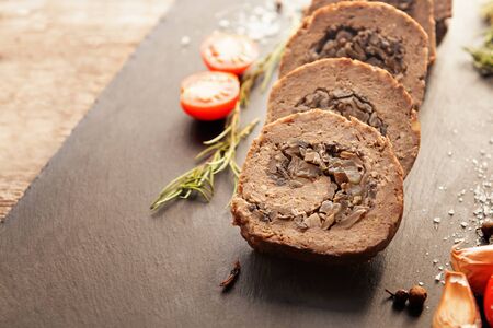 Tasty Meatloaf with mushrooms on wooden tableの写真素材