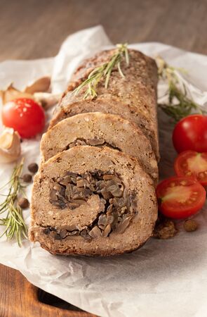 Tasty Meatloaf with mushrooms on wooden tableの写真素材