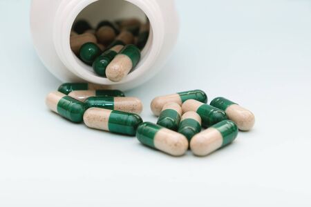Pill capsules on light blue background top view. Medical pharmacy conceptの写真素材