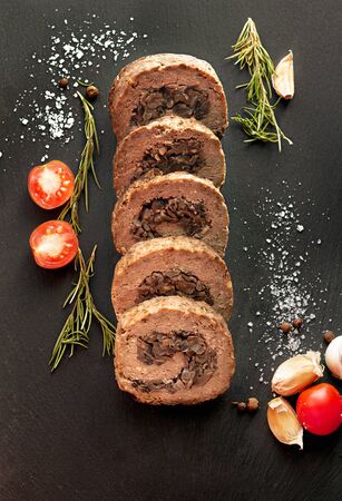 Tasty Meatloaf with mushrooms on black backgroundの写真素材