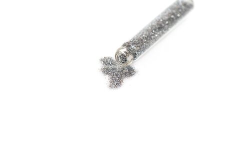 Silver colored glitter in transparent glass jar