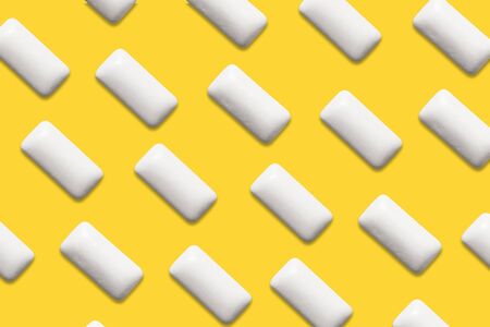 White chewing gum pattern on yellow backgroundの写真素材