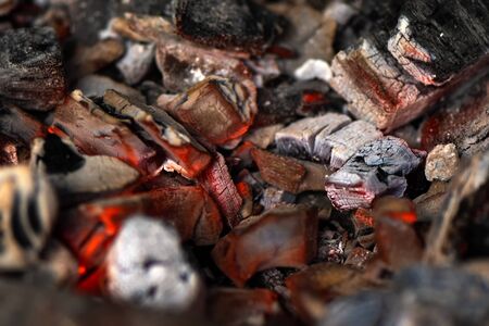 Burning coals in stove for cooking, close upの写真素材