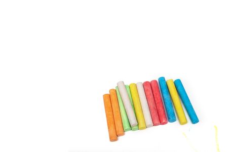 Colored crayons on a white sheet of paper