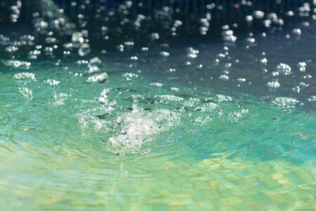 Water splash in the pool, close upの写真素材
