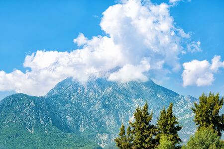 High mountains in the clouds, sunny weatherの写真素材