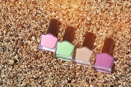 Nail polish bottles on a sea pebbles. Sammer varnish.