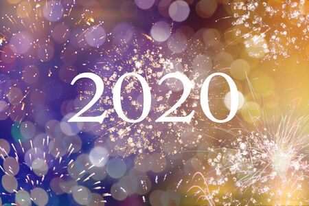 Happy new year 2020 written with Sparkle fireworks and bokeh
