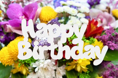 Happy birthday words on background with flowers.の写真素材