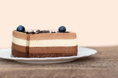 Triple chocolate mousse cake on white plateの写真素材
