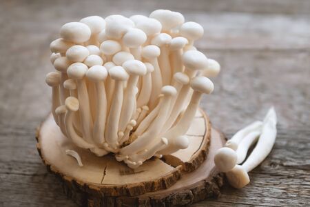 Enoki mushrooms on wooden background, close up