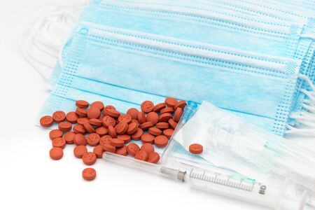 Protective medical mask, pills, syringe on white backgroundの写真素材