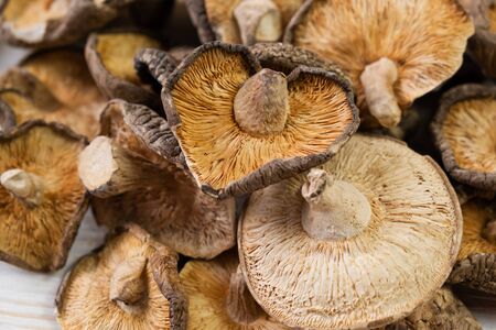 Close up of dried shiitake mushrooms on wooden background.の写真素材
