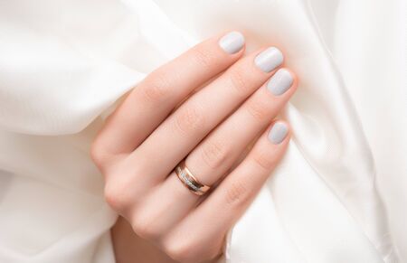 Glitter nail design. Female hand with gray manicureの写真素材