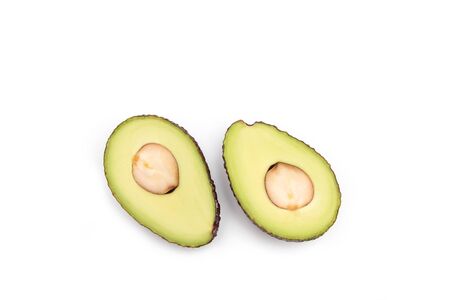 Avocado with cutted pit on a white background.