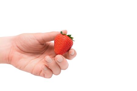 Strawberry in female hand isolated on a white background.の写真素材