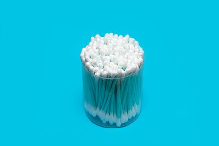 White cotton swabs on blue background.の写真素材