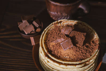 Sweet pancakes chocolate topping. Homemade pancakes with chocolate breakfast. Morning dessert cocoa pancakes on a plateの写真素材