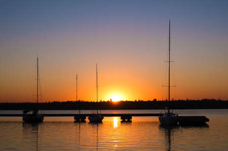 Beautiful sunset on the river. Boats sealing on sunset.