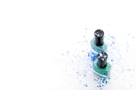 Two blue and cyan nail polish bottles on white background. Set of nail polish bottles with blue decorの写真素材