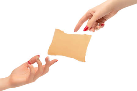 Female hands with red and golden nail polish. Creation of concept with piece of paper isolated on white backgroundの写真素材