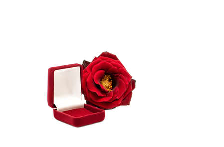 Red rose flower and a red empty ring box isolated on white background.