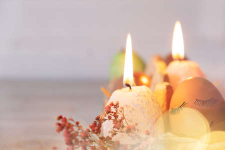 Easter egg with funny faces. Easter eggs with candles. burning candles