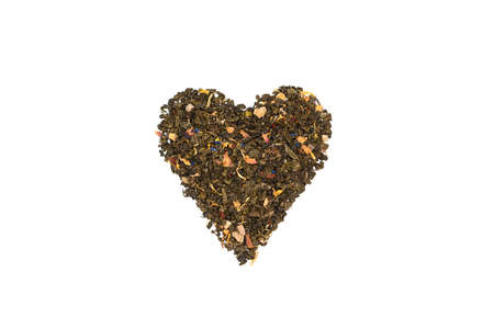 Heart symbol made from dried tea buds. Black tea heart shape isolated on whiteの写真素材