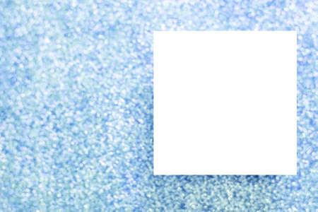 White paper frame on a blue glittery background. Copy space for greeting cardの写真素材