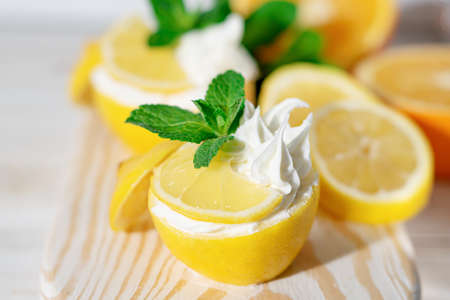 Homemade italian lemon sorbet decorated with mint. Homemade ice cream in lemon decorated with mint. Sorbetto al lemonの写真素材