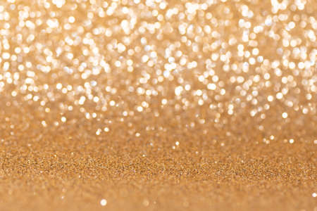 Glitter golden Christmas bokeh background. Shiny golden Christmas texture. New Year golden background. Christmas greeting card. copy space.の写真素材
