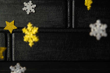 Golden and silver snowflakes on dark background.の写真素材